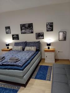 a bedroom with a bed and two tables and pictures on the wall at Zum Schinderhannes in Waibstadt