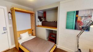 a small bedroom with a small bed in a room at Moab Flats #7 in Moab
