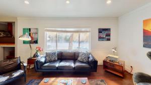 a living room with a leather couch and a table at Moab Flats #7 in Moab