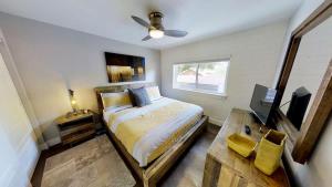 a bedroom with a bed and a television and a table at Moab Flats #8 in Moab