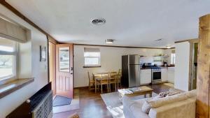 a living room with a couch and a kitchen at Pack Creek ~ Creekside West in Moab
