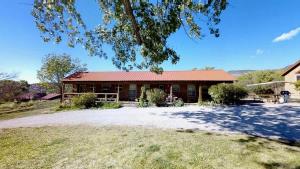 a house with a red roof and a yard at Pack Creek ~ Creekside West in Moab