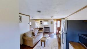 a living room with a couch and a refrigerator at Pack Creek ~ Creekside West in Moab +10 photos