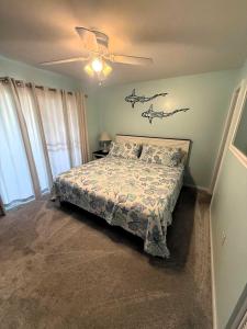 a bedroom with a bed and a ceiling fan at Lighthouse Point Rental 34A in Tybee Island +42 photos