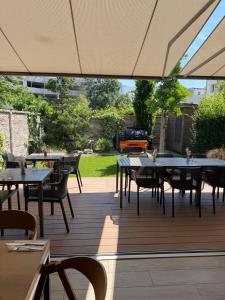 an outdoor patio with tables and chairs and an umbrella at La Brloh Pardubice in Pardubice