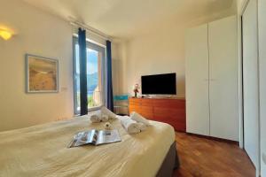 a bedroom with a bed with a tv on it at Gaeta 'Lake View' in San Siro