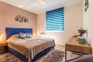 a bedroom with a large bed and a window at Sunset Resort 409 With Pool - Happy Rentals in Fonyód