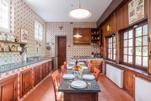 a kitchen with wooden cabinets and a table and chairs at Villa Colle in Ossuccio