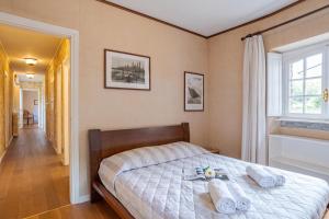 a bedroom with a bed with towels on it at Villa Colle in Ossuccio