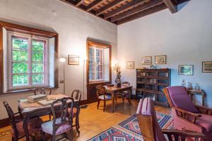 a living room with a table and chairs at Villa Colle in Ossuccio
