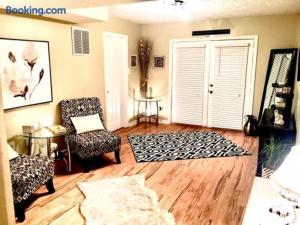 a living room with a chair and a door at The Haven at Charity House in Waldorf