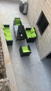 an overhead view of a table and chairs with green cushions at Casa El Haje in Al Maşyaf