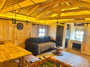 a living room with a couch and a table at Domki nad morzem Sasino Mojo Miodno Checz in Sasino