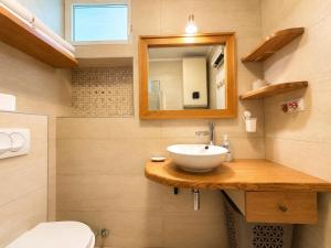 a bathroom with a sink and a mirror and a toilet at Alex Apartments in Budva +34 photos