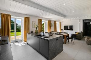 a living room with a kitchen and a dining room at Glebe House in Sion Mills