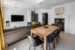 a living room with a couch and a table and chairs at Glebe House in Sion Mills