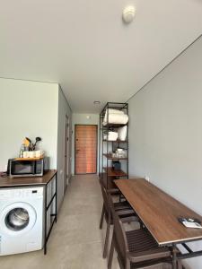 a laundry room with a washing machine and a table at Sunny Gardens in Shekhvetili