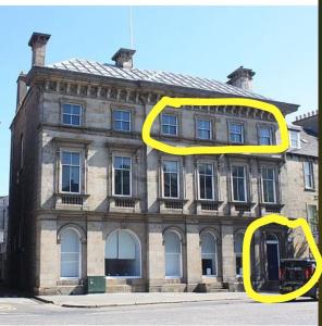 a yellow pair of eyes in front of a building at Bernard Street Edinburgh Apartment in Edinburgh