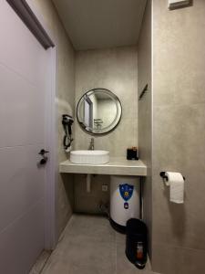 a bathroom with a sink and a mirror at Sunny Gardens in Shekhvetili