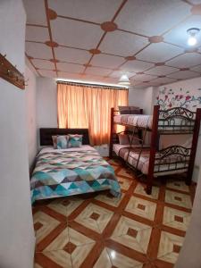 a bedroom with a bed and a bunk bed at GoldenBird Mindo in Mindo