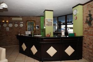 a counter in a restaurant with a clock on the wall at Resort Nord Park in Fushë-Krujë +91 photos