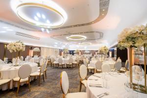 a banquet hall with white tables and chairs at Crowne Plaza Belgrade by IHG in Belgrade +223 photos