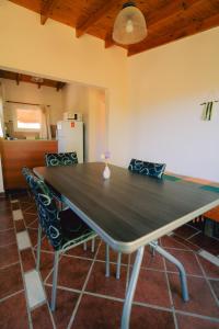 a dining room table with two chairs and a refrigerator at Entre Campos in Los Reartes