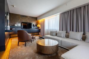 a living room with a couch and a table at Crowne Plaza Belgrade by IHG in Belgrade
