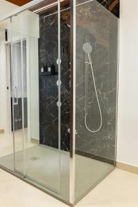a shower with a glass enclosure in a room at Villa delle Rose Pompei Rooms and Suite in Pompei