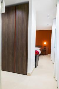 a corridor of a hospital room with wooden wardrobes at Villa delle Rose Pompei Rooms and Suite in Pompei +94 photos