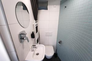 a bathroom with a sink and a toilet and a mirror at slube am Krakower See in Krakow am See