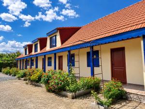 a row of houses with flowers in front of them at Casa KariAna in Murighiol
