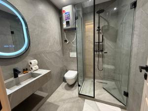a bathroom with a shower and a toilet at Living Fleuri Suites & Studios in Casablanca +55 photos
