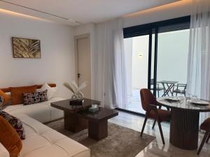 a living room with a couch and a table at Living Fleuri Suites & Studios in Casablanca
