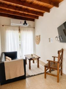a living room with a couch and a table at Mirando al Mar I in Mar Azul