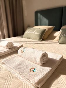 two towels sitting on top of two beds at Complejo GOOD LIFE in Miramar
