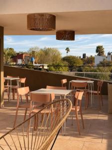 a patio with tables and chairs on a roof at Complejo GOOD LIFE in Miramar