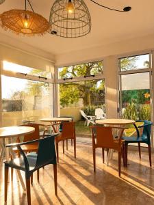 a room with tables and chairs and windows at Complejo GOOD LIFE in Miramar