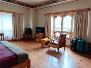 a bedroom with a bed and a desk and a television at Dream Janka Boutique in Paro