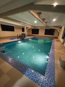 a swimming pool in a house with a tile floor at Dream Janka Boutique in Paro