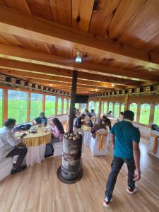 a group of people sitting at tables in a restaurant at Dream Janka Boutique in Paro +48 photos