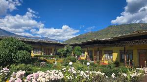 a house with a garden with flowers in front of it at Dream Janka Boutique in Paro