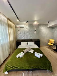 a bedroom with a bed with two towels on it at SMART COASTAL RETREAT Apartment in Alexandroupoli