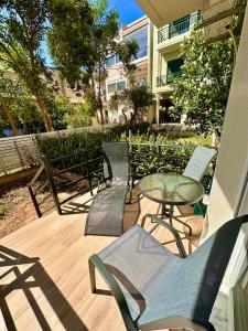 a patio with chairs and a table and a building at SMART COASTAL RETREAT Apartment in Alexandroupoli