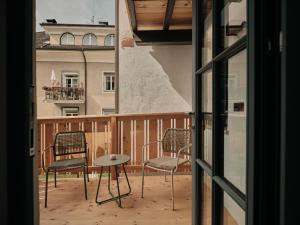 a view of a balcony with chairs and a table at Stuveles Apartments in Brixen