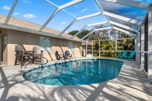 a pool on a patio with chairs and a table at Paradise Vacay in Sebastian