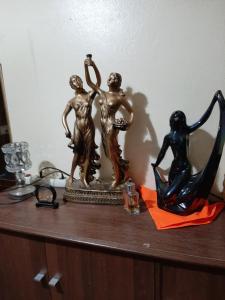 a shelf with a statue of two women and a harp at Mini-villa ajdir in Ajdir