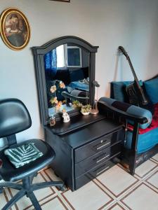 a desk with a mirror and a chair in a room at Mini-villa ajdir in Ajdir