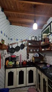a kitchen with pots and pans on the wall at Mini-villa ajdir in Ajdir +12 photos