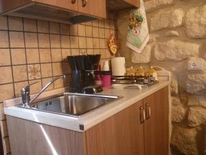 a kitchen with a sink and a counter top at Piccolo Dammusu in Scicli